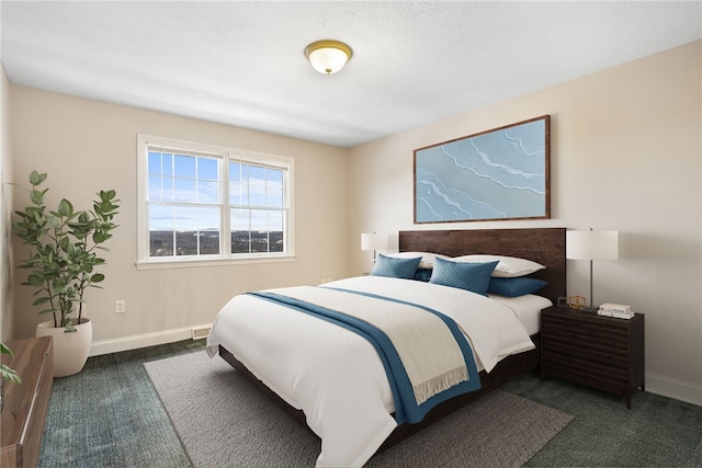 bedroom featuring dark carpet and a textured ceiling