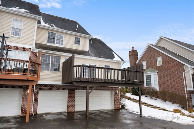 snow covered property featuring a garage