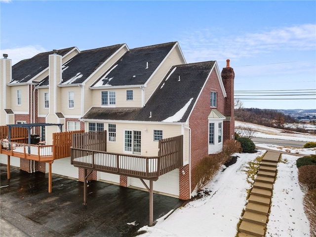 snow covered property featuring a deck