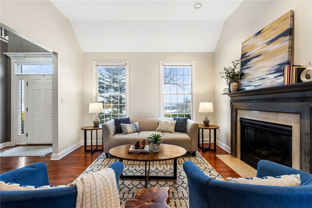 living room featuring dark wood-type flooring and vaulted ceiling