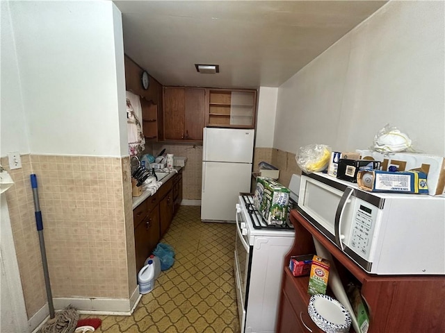 kitchen with sink and white appliances