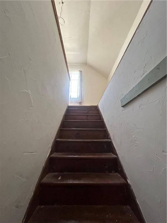 staircase featuring lofted ceiling