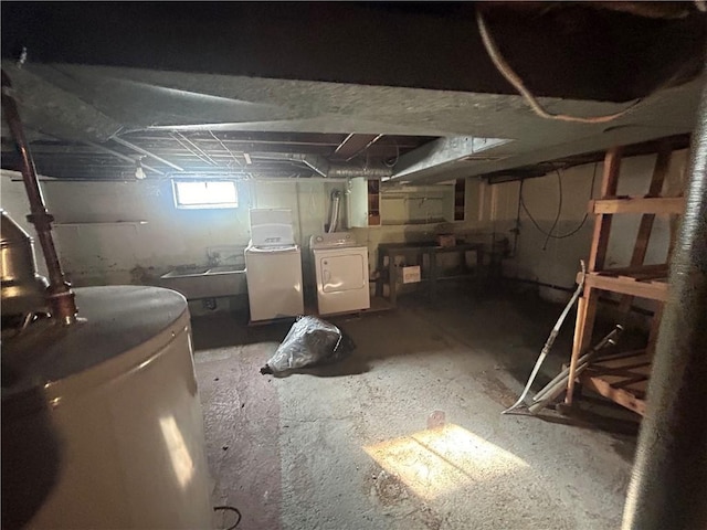 basement with washing machine and dryer and water heater