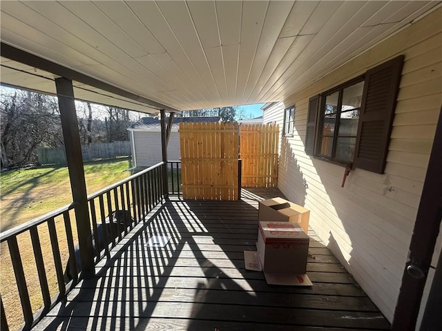 wooden deck with a lawn