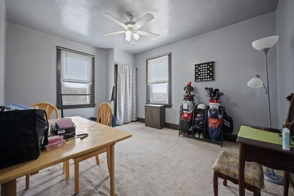 office area featuring light carpet and ceiling fan