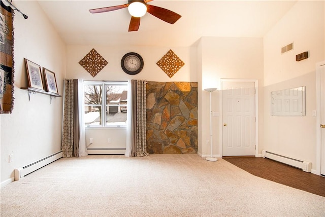 unfurnished living room featuring ceiling fan, a baseboard radiator, and carpet floors