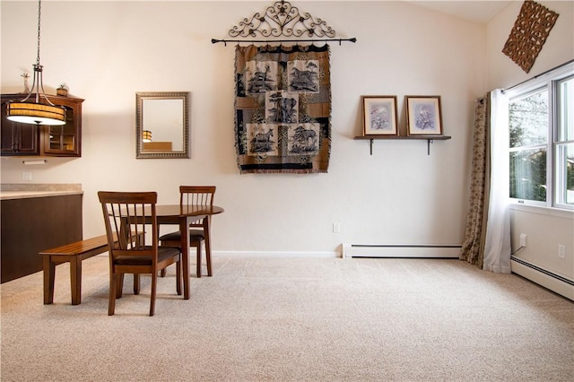 carpeted dining area featuring a baseboard heating unit and a wealth of natural light