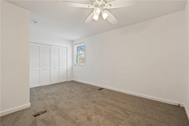 unfurnished bedroom with carpet floors, ceiling fan, and a closet