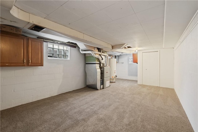 basement with carpet floors, heating unit, and gas water heater