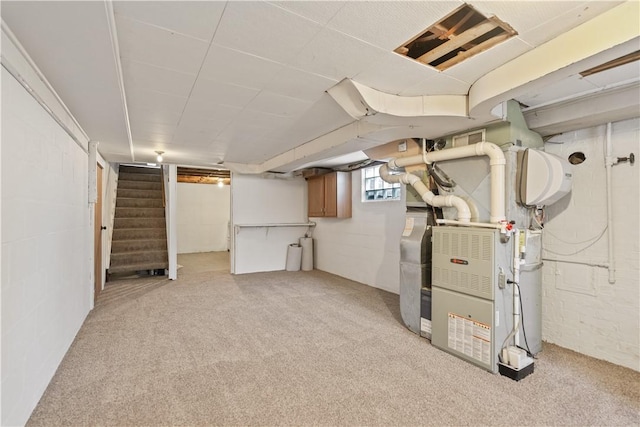 basement with light carpet and heating unit