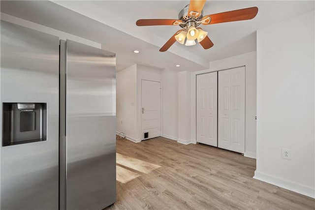 kitchen with light wood-type flooring and stainless steel fridge with ice dispenser