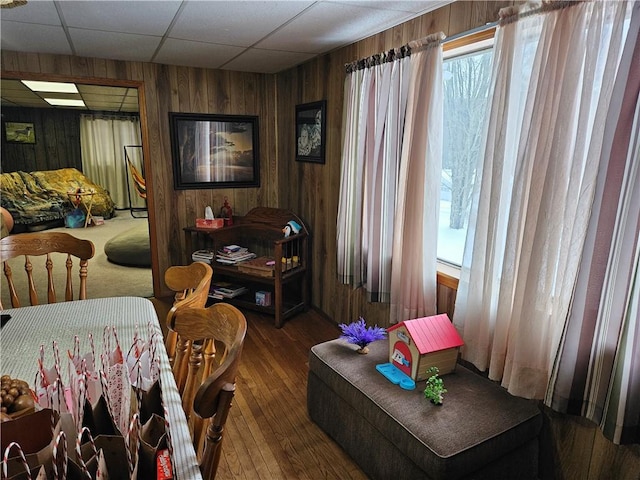 sitting room featuring hardwood / wood-style flooring and wood walls