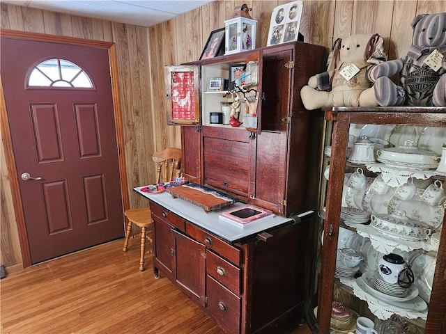 office featuring light hardwood / wood-style flooring and wood walls