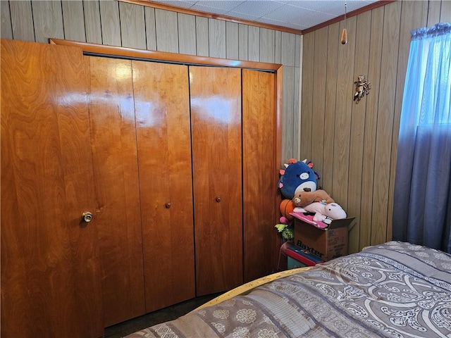 unfurnished bedroom featuring a closet and wood walls