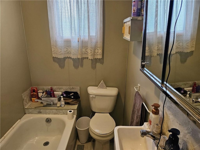 bathroom featuring a tub to relax in and toilet