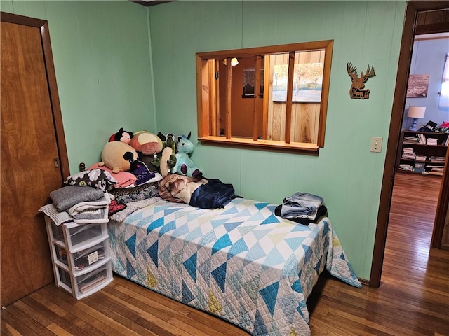 bedroom with dark hardwood / wood-style floors