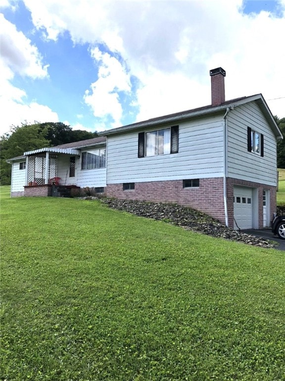 exterior space with a garage and a front lawn