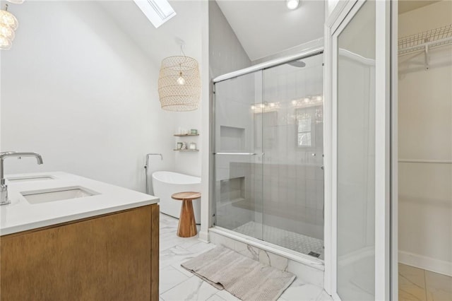 full bathroom featuring a shower stall, marble finish floor, double vanity, a sink, and lofted ceiling with skylight