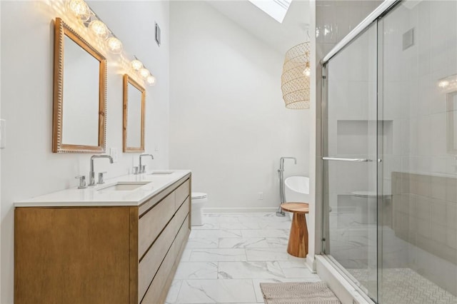 bathroom featuring a skylight, marble finish floor, a sink, and a stall shower