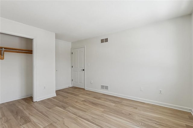 unfurnished bedroom featuring light wood-style flooring, visible vents, and baseboards