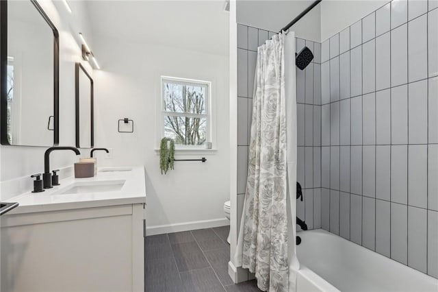 full bathroom with shower / tub combo, baseboards, a sink, and toilet