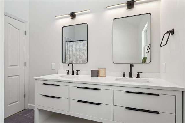 bathroom with a sink and double vanity