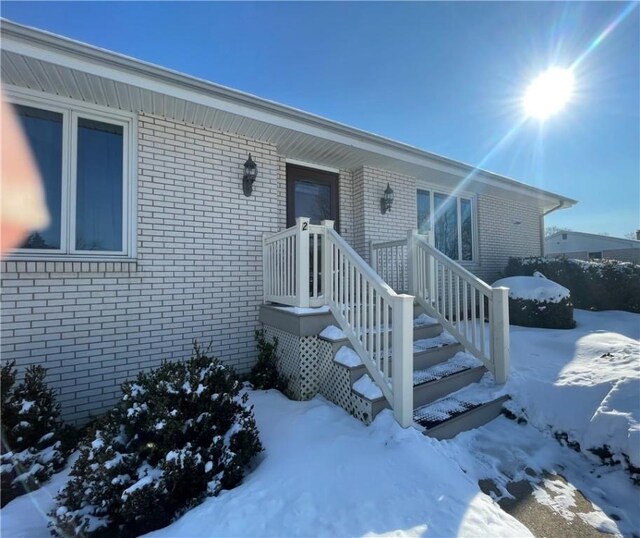 view of snow covered property entrance