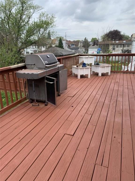 wooden deck featuring a grill