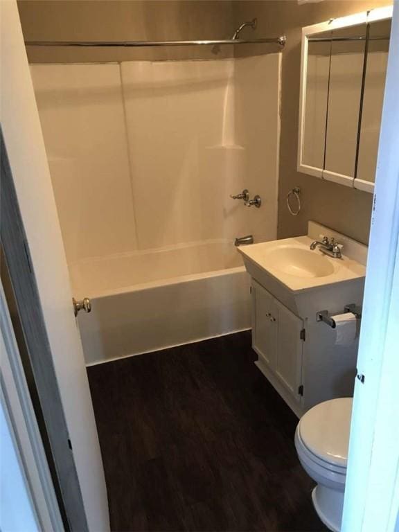 full bathroom with vanity, toilet, bathing tub / shower combination, and hardwood / wood-style floors