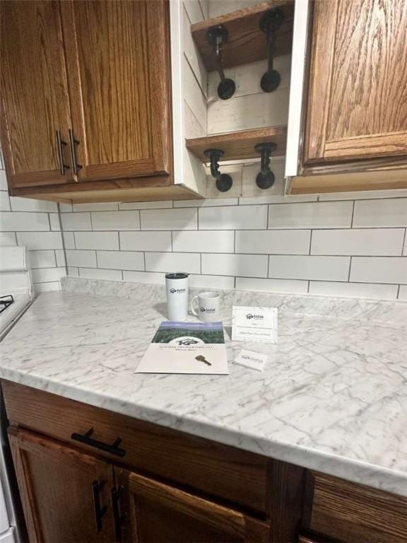 448 Baldwin Ave, Sharon, PA 16146 - kitchen featuring tasteful backsplash, open shelves, brown cabinetry, and light stone counters