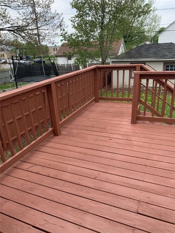448 Baldwin Ave, Sharon, PA 16146 - wooden terrace featuring a trampoline and a fenced backyard