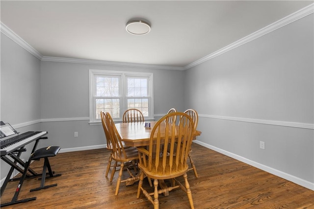 dining area featuring dark wood-type flooring and ornamental molding