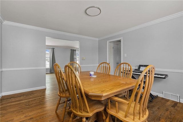 dining room featuring crown molding and dark hardwood / wood-style floors