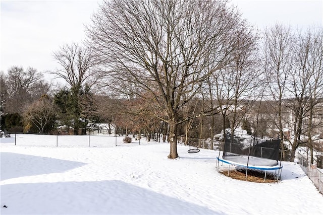 snowy yard with a trampoline