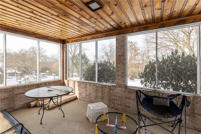 sunroom featuring a wealth of natural light and wood ceiling