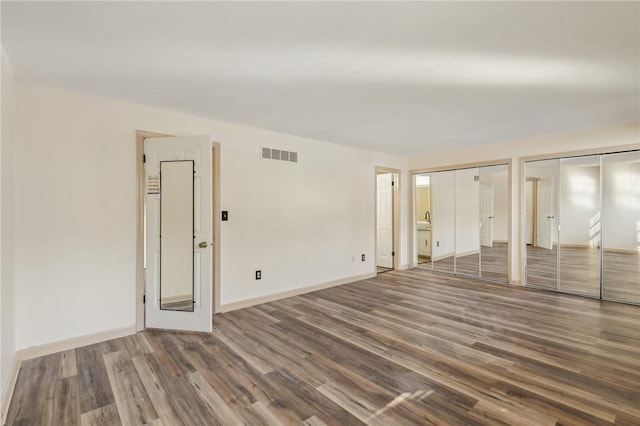 spare room with dark wood-type flooring