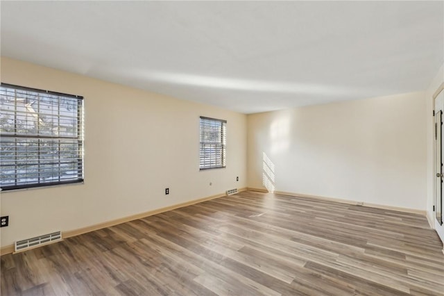 spare room featuring light hardwood / wood-style flooring