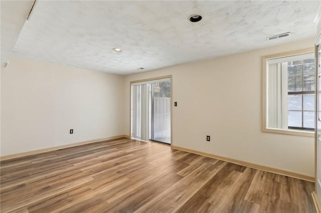 spare room with light hardwood / wood-style flooring