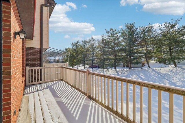 view of snow covered back of property