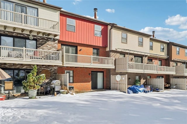 view of snow covered rear of property