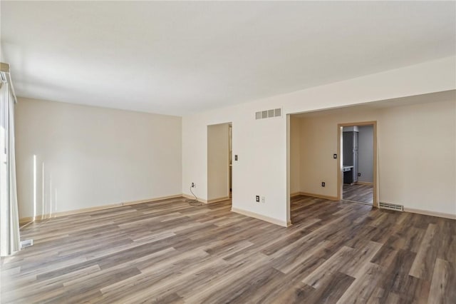 spare room with hardwood / wood-style floors