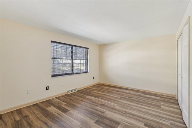 unfurnished bedroom featuring hardwood / wood-style floors and a closet