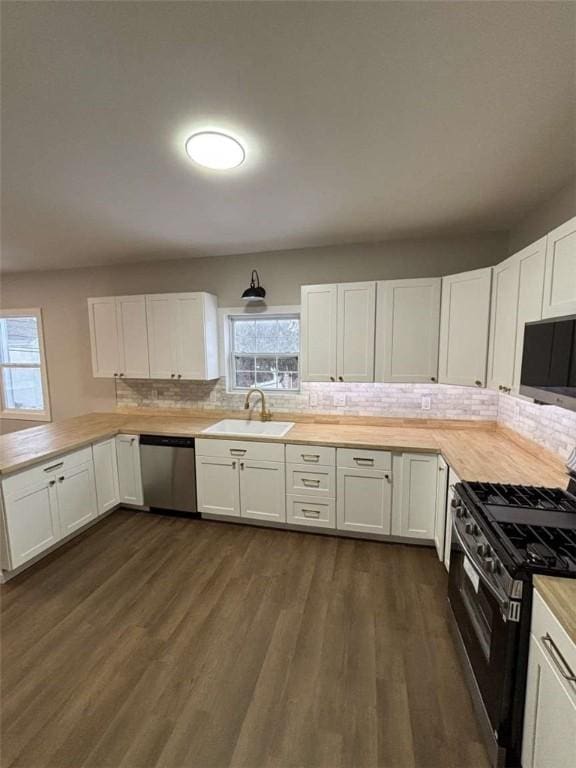 kitchen featuring sink, gas stove, white cabinetry, wooden counters, and stainless steel dishwasher