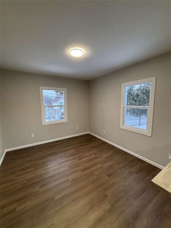 spare room with dark hardwood / wood-style floors