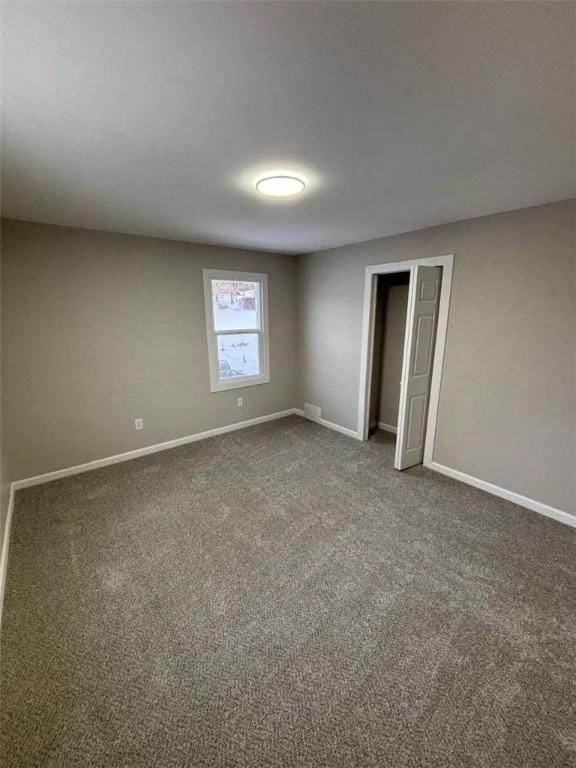 unfurnished bedroom featuring dark colored carpet