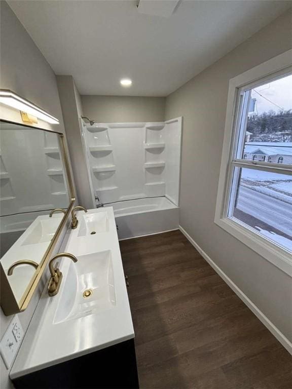 bathroom featuring vanity, hardwood / wood-style floors, and shower / bathtub combination