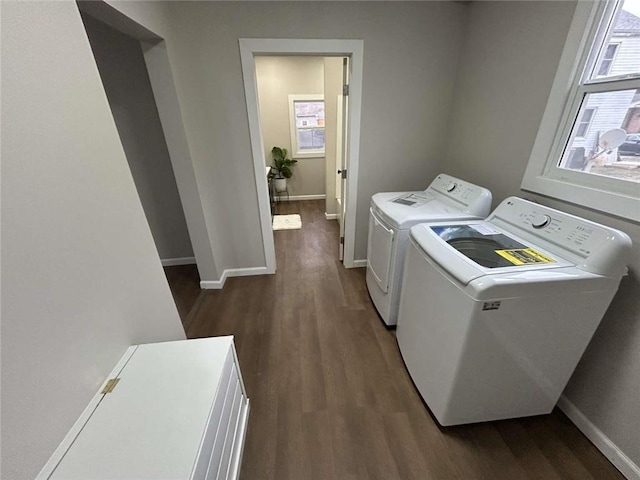 washroom featuring dark hardwood / wood-style floors and washing machine and clothes dryer