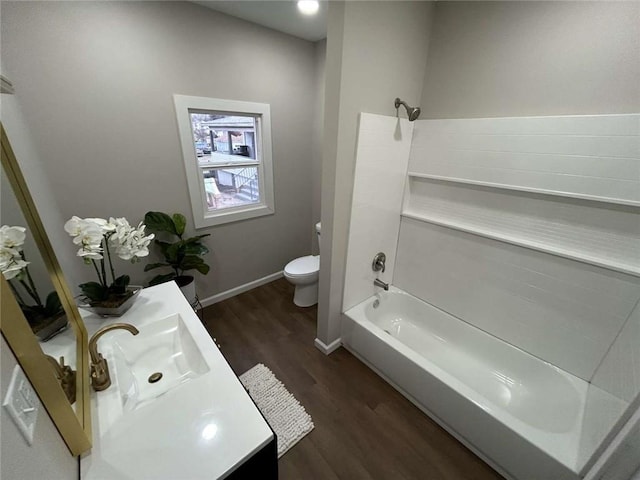 full bathroom featuring vanity, hardwood / wood-style flooring,  shower combination, and toilet