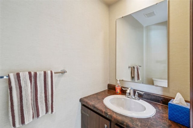 bathroom with vanity and toilet