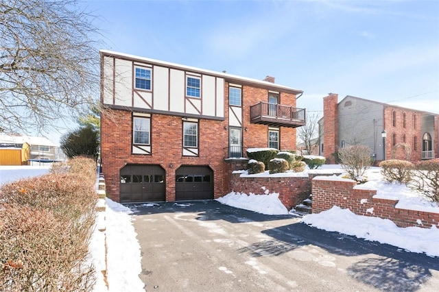 view of front of home with a balcony and a garage